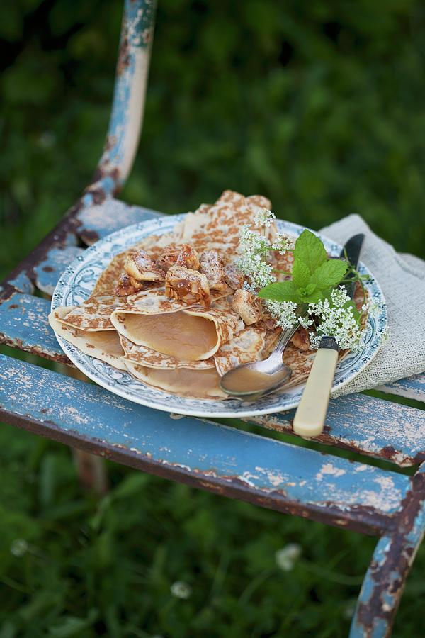 Pancakes Filled With Apple Sauce On Vintage-style Plate #1 Photograph by Martina Schindler