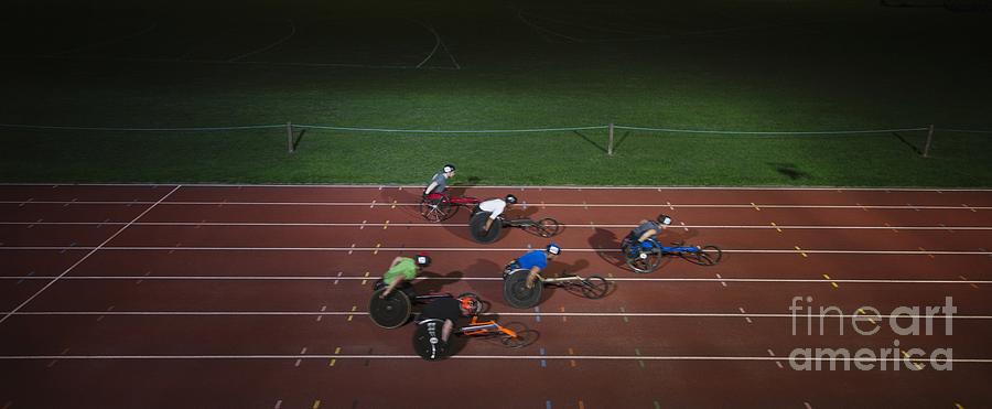 Ambition Photograph - Paraplegic Athletes Racing Along Sports Track In Night by Caia Image/science Photo Library Ambition Photograph - Paraplegic Athletes Racing Along Sports Track In Night by Caia Image/science Photo Library