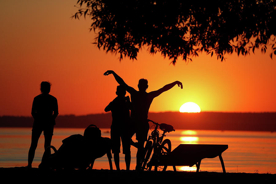 Nature Photograph - People Enjoy Sunset at a Lake #1 by Vasily Fedosenko
