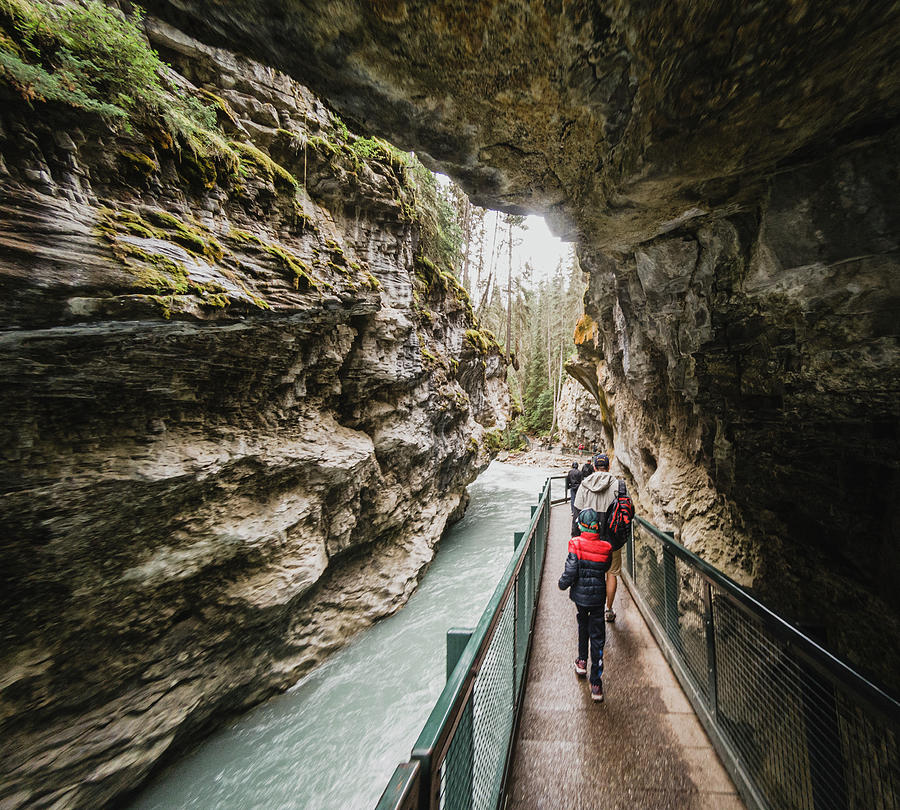 Banff National Park Photograph - People Walking On Metal Catwalk Alongside The Flowing Water In Canyon. #1 by Cavan Images