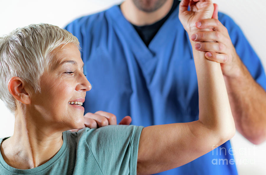 Physical Therapist Examining Patients Arm #1 Photograph by Microgen Images/science Photo Library
