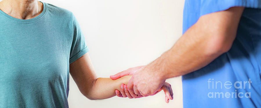 Physical Therapist Examining Patients Wrist #1 Photograph by Microgen Images/science Photo Library