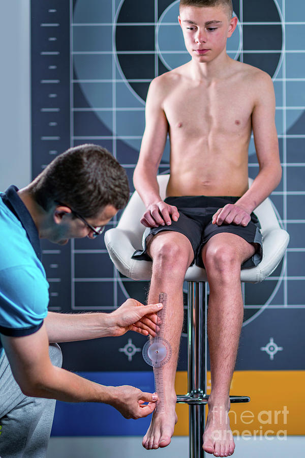 Physical Therapist Measuring Teenage Boys Shin #1 Photograph by Microgen Images/science Photo Library