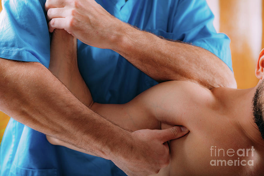 Physiotherapist Massaging Athletes Shoulder #1 Photograph by Microgen Images/science Photo Library