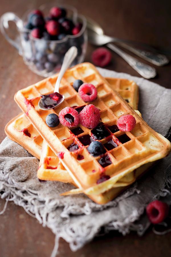 Pile Of Plain Brussels Waffles With Red Berry Coulis #1 Photograph by Hallet
