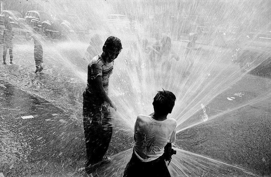 Black And White Photograph - Playing With A Fire Hydrant #3 by Peter Stackpole