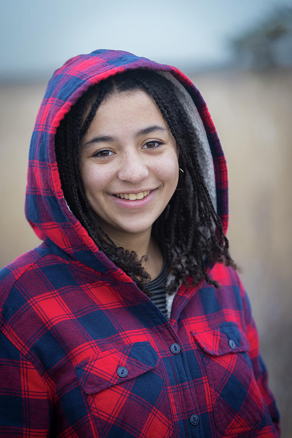 Portrait Of Biracial Young Woman Smiling With Braids And Hood ...