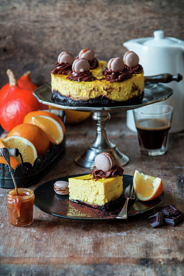 Pumpkin And Orange Cheesecake With A Brownie Base And Macarons #1 Photograph by Irina Meliukh