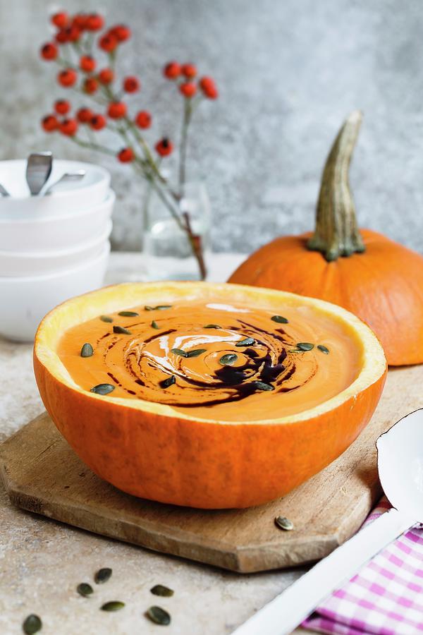 Pumpkin Soup With Pumpkin Seeds And Pumpkin Oil #1 Photograph by Brigitte Sporrer