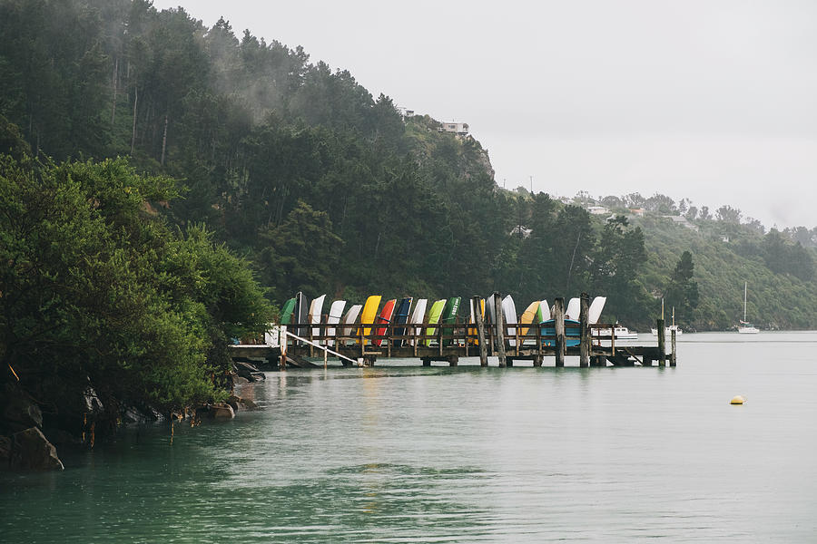 Boat Photograph - Purau Bay Colourful Boats On A Jetty On A Cloudy Day, Banks Peninsula #1 by Cavan Images