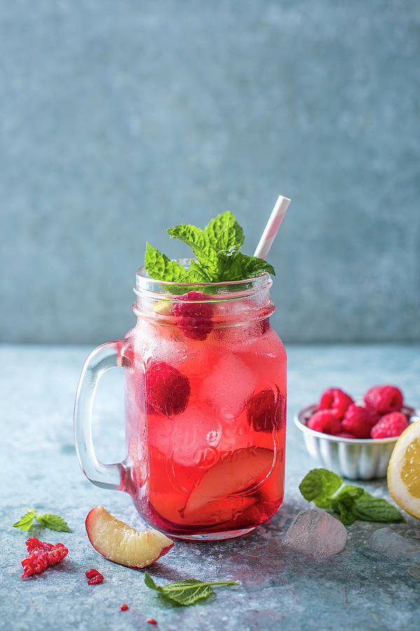 Raspberry And Peach Iced Tea With Mint And Ice #1 Photograph by Magdalena Hendey