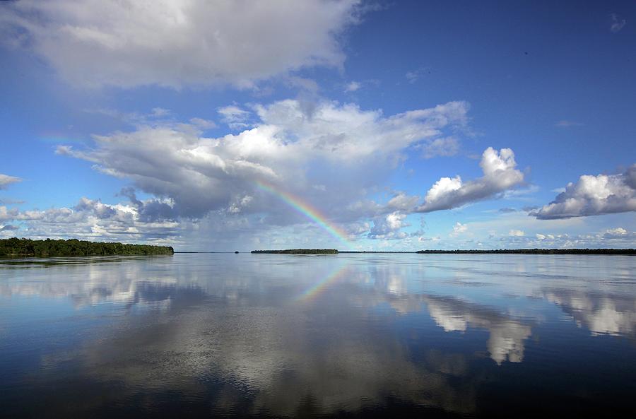 Rio Negro & Reflections Of An Amazonian #1 Photograph by Timothy Allen