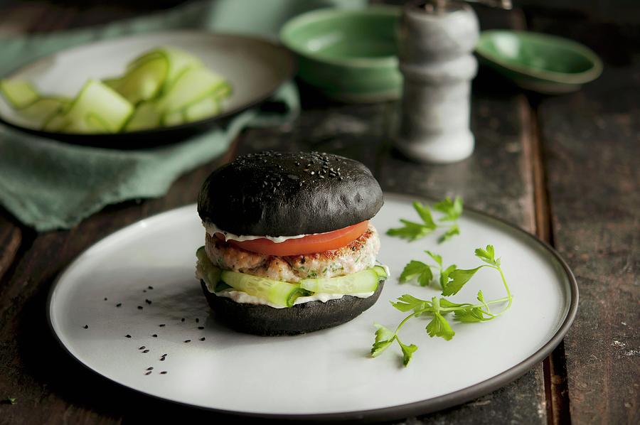 Salmon Fillet On A Black Burger Bun #1 Photograph by Kristy Snell