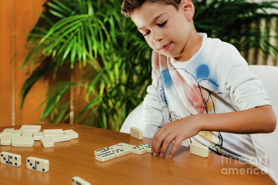 Schoolboy Playing Dominoes #1 Photograph by Microgen Images/science Photo Library
