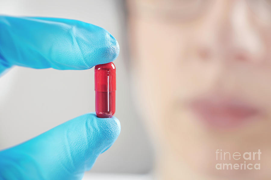 Scientist Holding A Red Pill #1 Photograph by Microgen Images/science Photo Library
