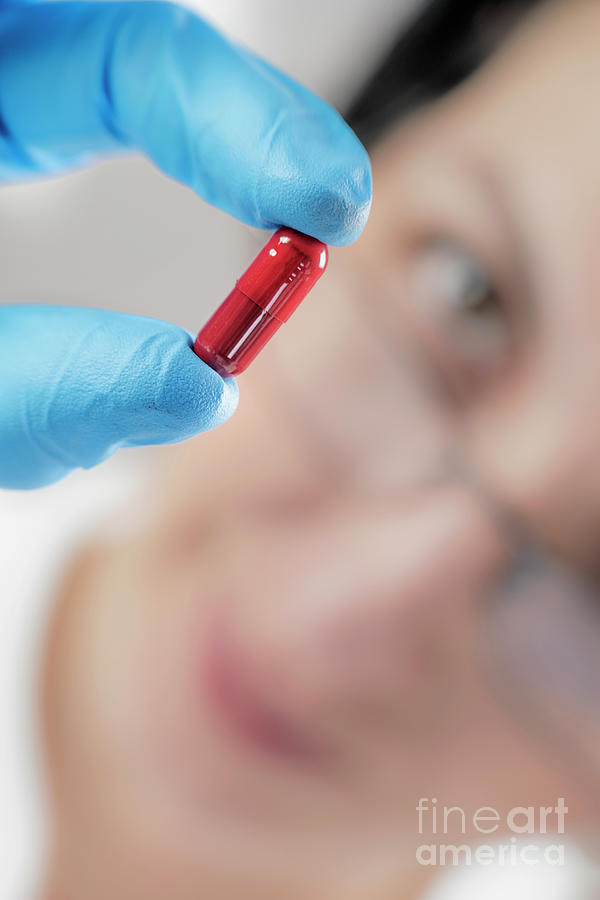 Scientist Holding Red Pill #1 Photograph by Microgen Images/science Photo Library