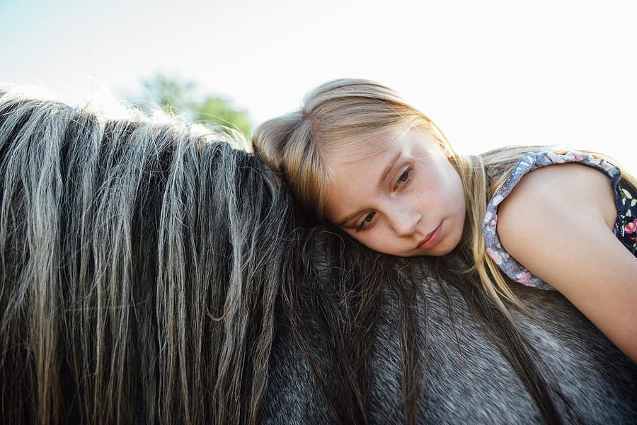 Side View Of Thoughtful Girl Lying On Horse Against Clear Sky #1 Photograph by Cavan Images Side View Of Thoughtful Girl Lying On Horse Against Clear Sky #1 Photograph by Cavan Images