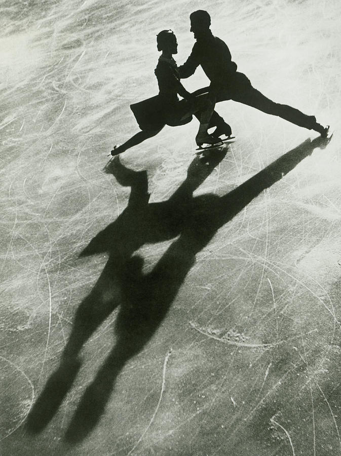 Silhouette Of Couple Ice Skating #1 Photograph by Fpg