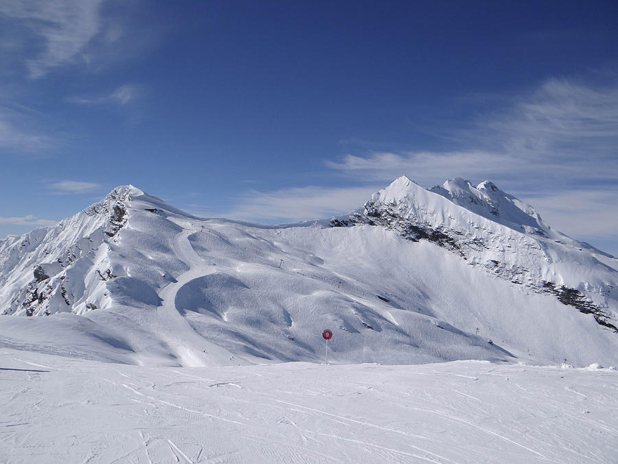 Skiers descend open slopes #1 Photograph by Steve Estvanik