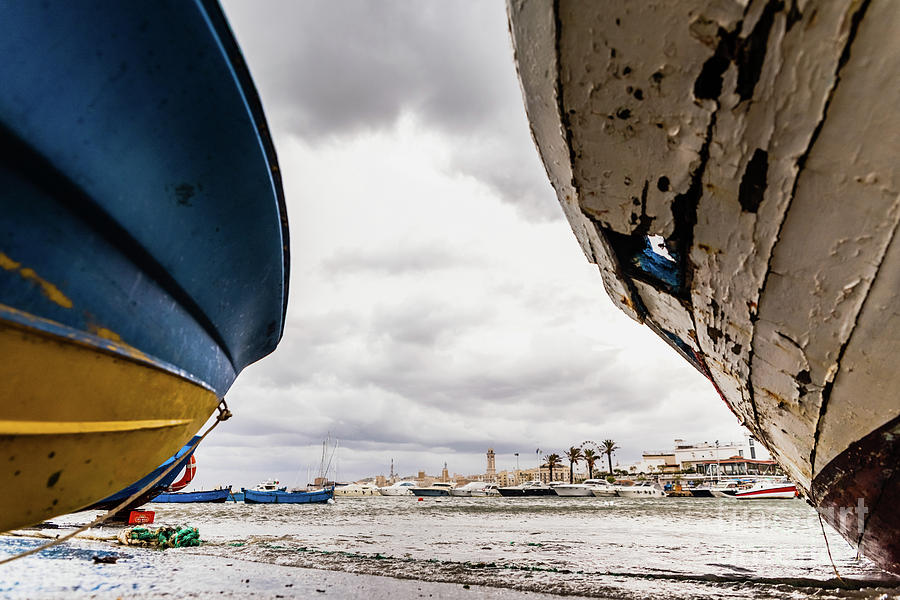 Small boat moored to Bari port, Italy, during a storm at sea. #2 Photograph by Joaquin Corbalan