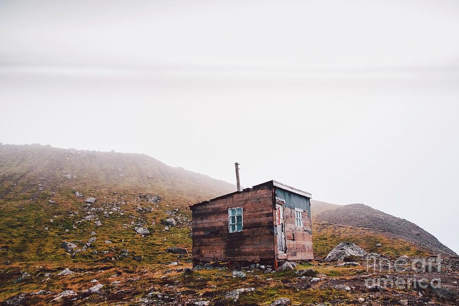 Small wooden hut on top of a mountain surrounded by fog in winter to seek solitude. #1 Photograph by Joaquin Corbalan
