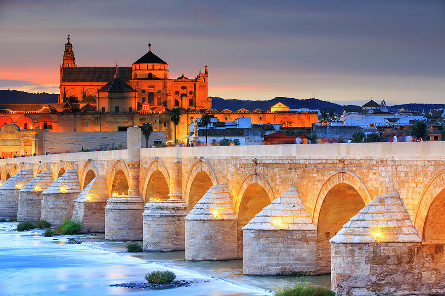 Spain, Andalusia, Cordoba District, Cordoba, La Mezquita Cathedral With The Roman Bridge And Guadalquivir River At Dusk #1 Digital Art by Maurizio Rellini