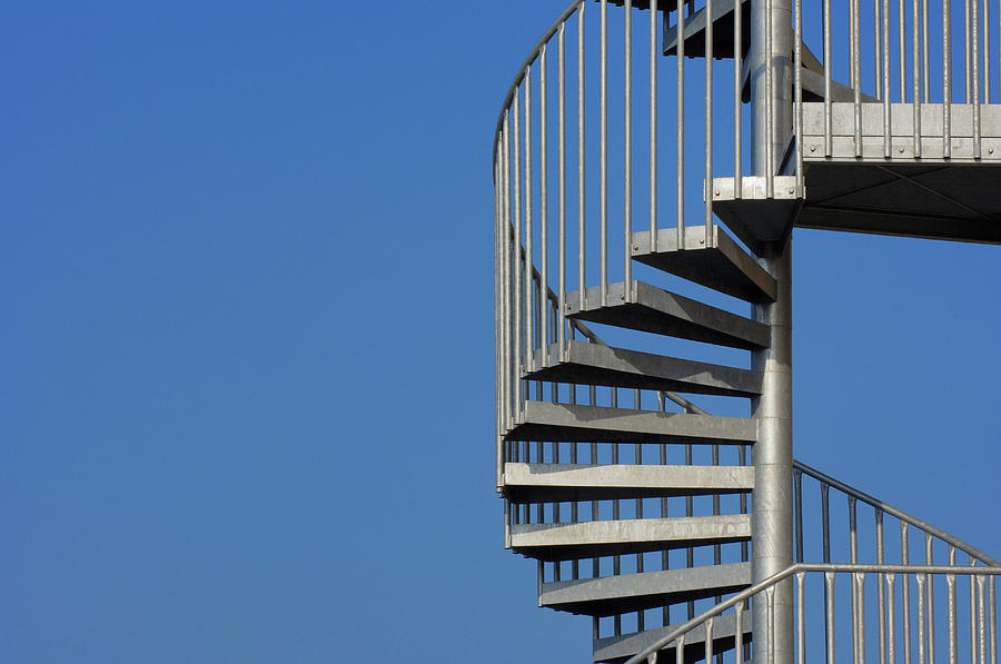 Spiral Staircase Against A Blue Sky #1 Photograph by Martin Ruegner