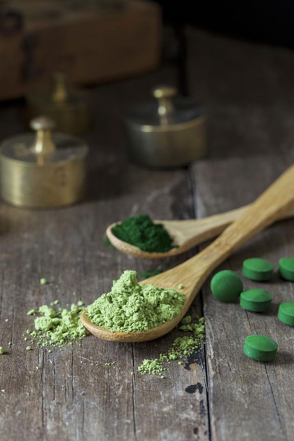Spirulina Tablets And Spirulina Powder On Wooden Spoons #1 Photograph by Nicole Godt