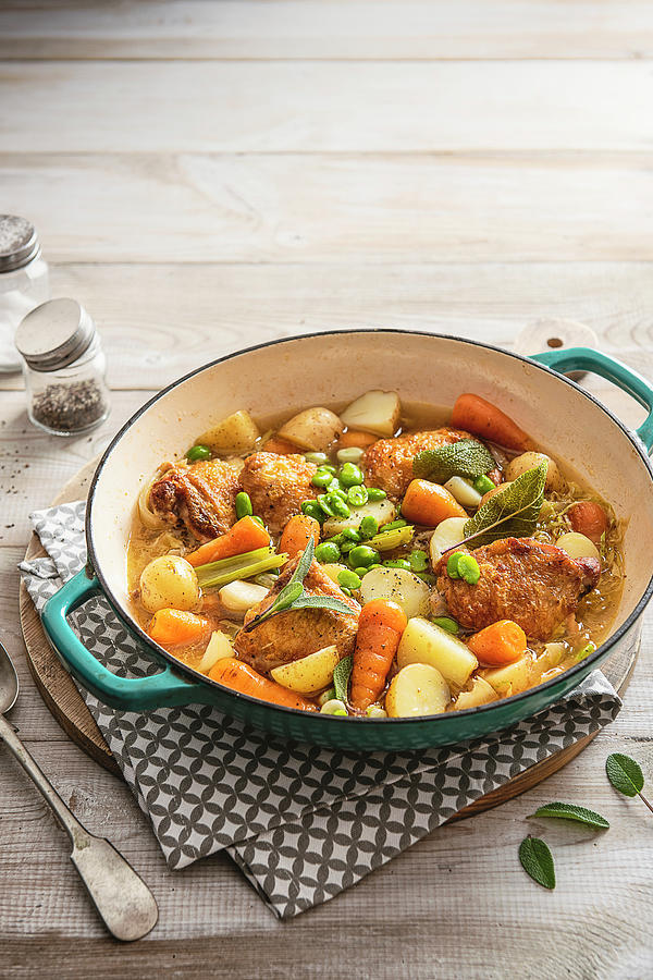 Spring Casserole With Chicken Tights, New Potatoes, Baby Carrots, Young Cabbage, Broad Beans And Sage #1 Photograph by Magdalena Hendey