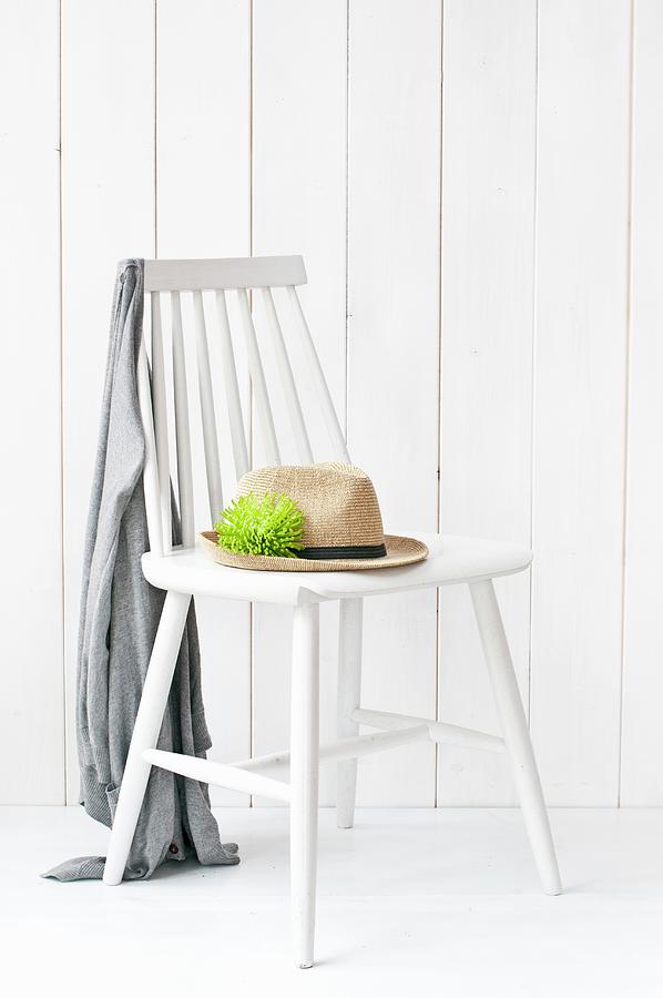 Summer Hat With Green Chrysanthemum anastasia In Hat Band On White Wooden Chair #1 Photograph by Cornelia Weber