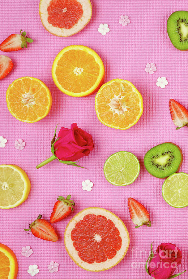 Summer theme background with fruit, citrus and flowers on pink backdrop. #1 Photograph by Milleflore Images