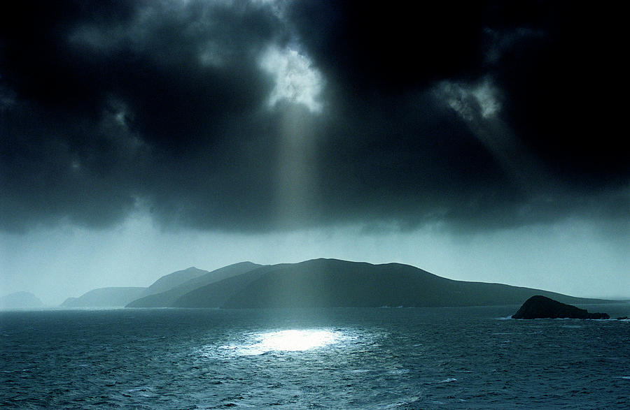 Sunbeams Shining Through Dark Cloud Cover At Dingle Bay, Great Blasket Island, County Kerry, Ireland, Europe #1 Photograph by H.& D. Zielske