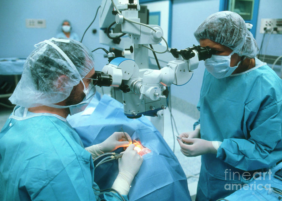 Surgeons Using Microscope To Carry Out Eye Surgery #1 Photograph by Klaus Guldbrandsen/science Photo Library
