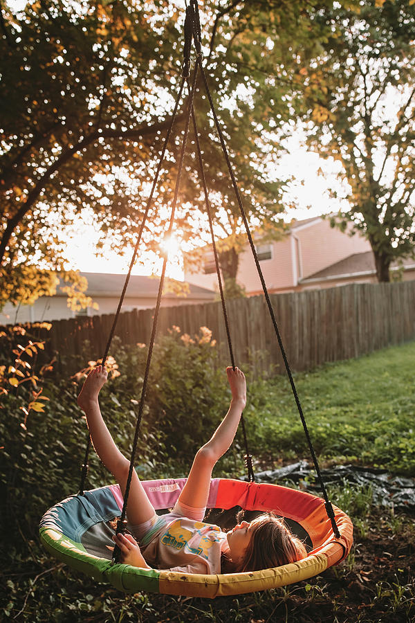 Swinging On Her Tree Swing At Sunset Photograph by Cavan Images - Fine ...