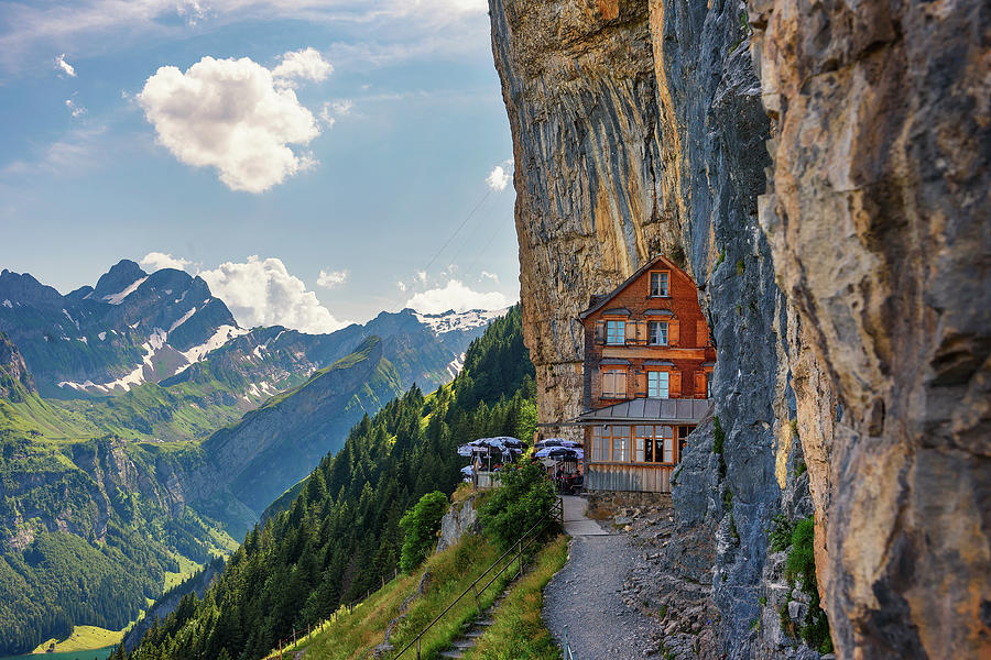 Swiss Alps and a restaurant under a cliff on mountain Ebenalp in ...