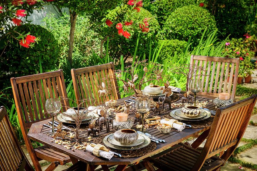 Table Set For Christmas Dinner In Garden With Elegant African-style Decorations #1 Photograph by Great Stock!