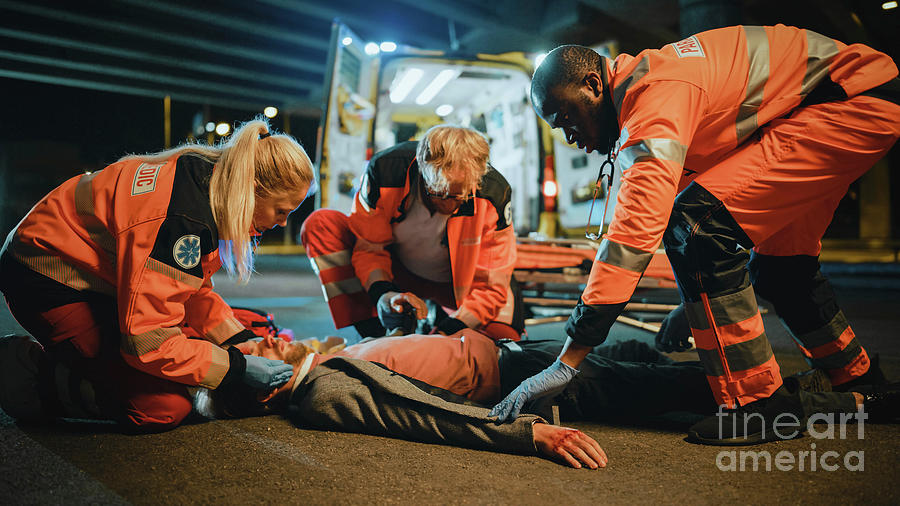 Team Of Paramedics Providing Medical Help #1 Photograph by Gorodenkoff Productions/science Photo Library