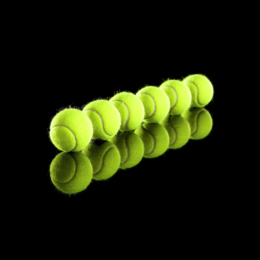 Tennis Balls In Row #1 Photograph by Thomas Northcut