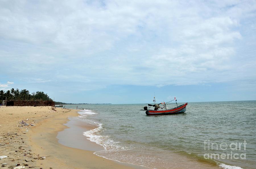 Thai fishing boat with motor parked at sea by beach in Pattani fishing village Thailand #2 Photograph by Imran Ahmed