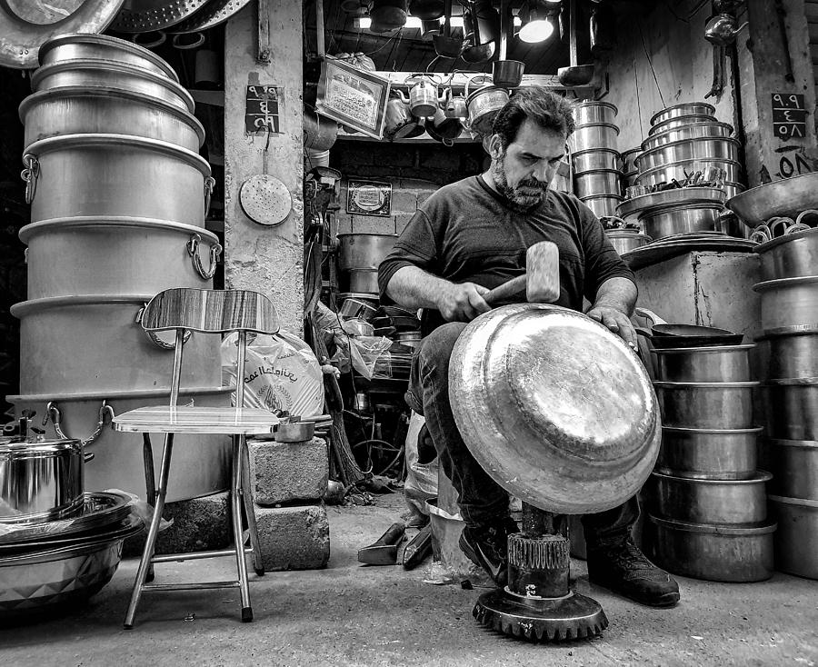 Man Photograph - The Profession Of Manufacturing Traditional Kitchen Utensils From Aluminum Manually #1 by Bashar Alsofey