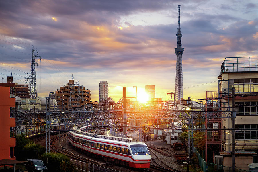 Train in city in Tokyo with sunset background #1 Photograph by Anek Suwannaphoom
