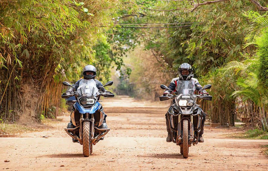 Jungle Photograph - Two Men Riding Their Adventure Motorbike On Dirt Road In Cambodia #1 by Cavan Images
