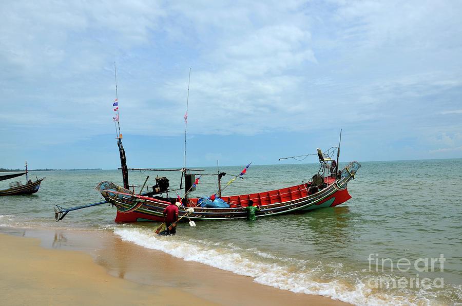 Two Thai fishermen take equipment onto boat at seaside Pattani Thailand #2 Photograph by Imran Ahmed