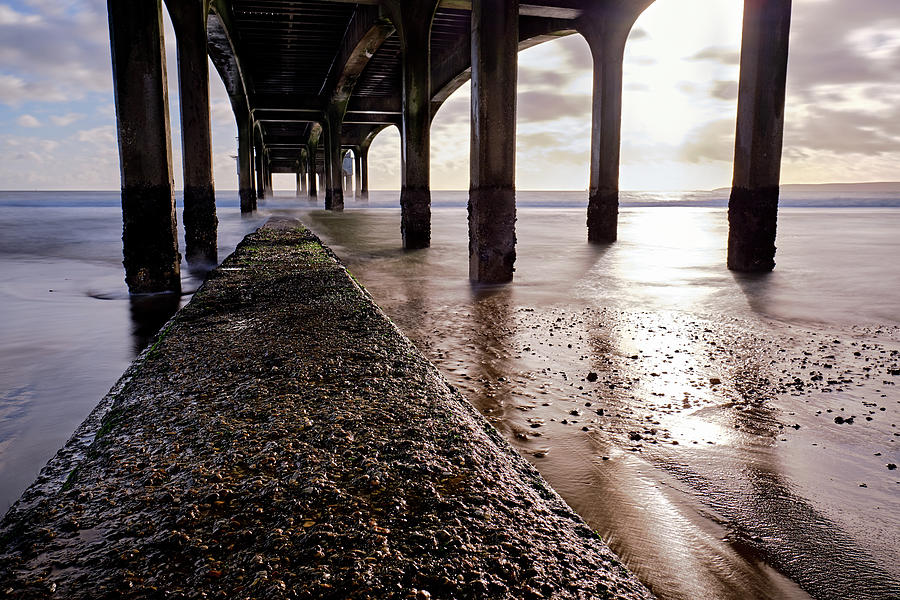 Underneath Pier Out To Sea, Cloudy Sky Photograph by Cavan Images ...