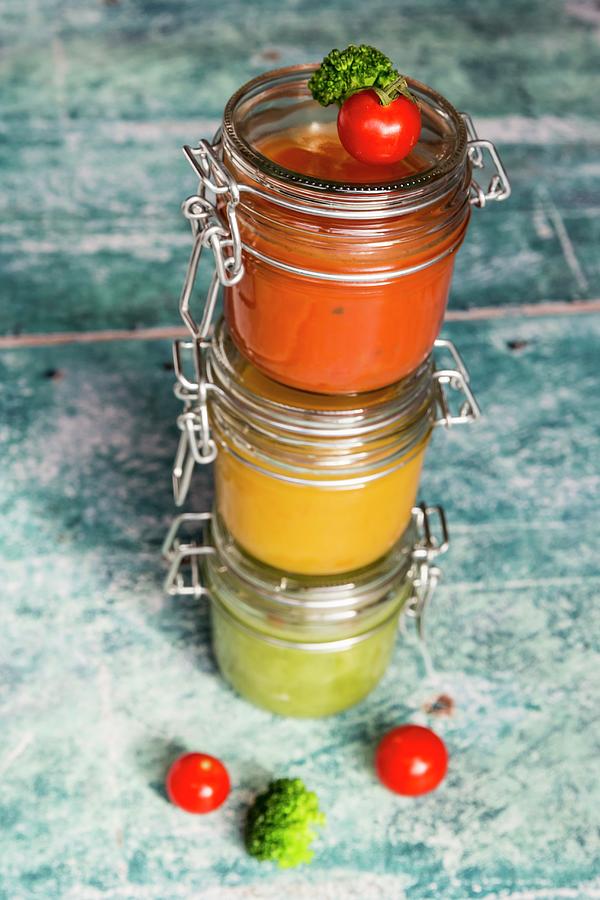 Various Colourful Soups In Glass Jars broccoli Soup, Tomato Soup, Pumpkin Soup #1 Photograph by Sandra Rsch
