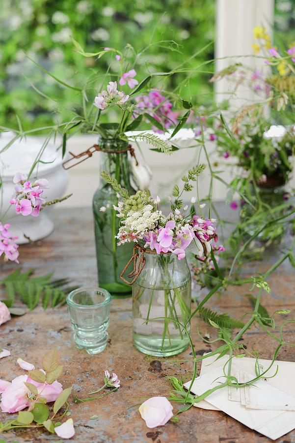 Vases Of Wildflowers On Worn Table Below Window #1 Photograph by Irene Berni