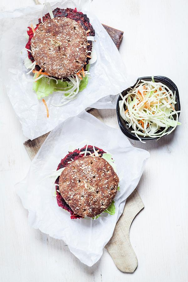 Vegan Wholemeal Burgers With Shredded Cabbage, Carrots, Lettuce And Beetroot Fritters #1 Photograph by Susan Brooks-dammann