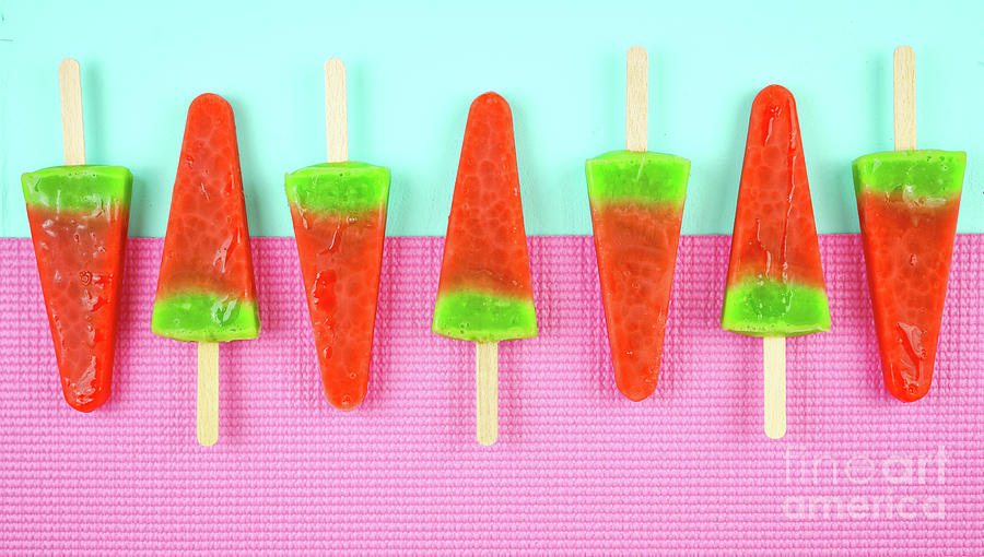 Watermelon flavored summer ice cream popsicles on pink and blue background. #1 Photograph by Milleflore Images