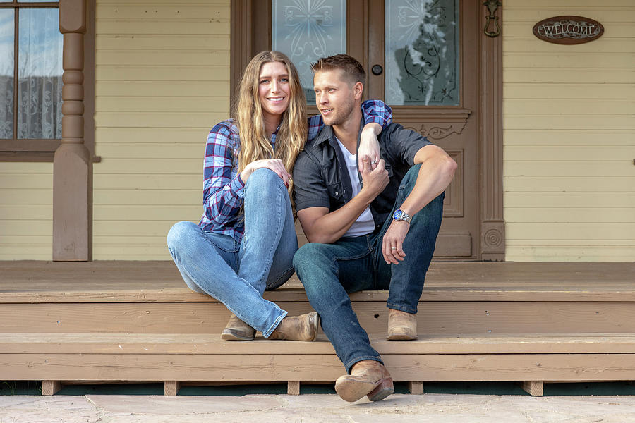 Western Wear Young Couple Sitting On Front Porch Of Ranch House ...