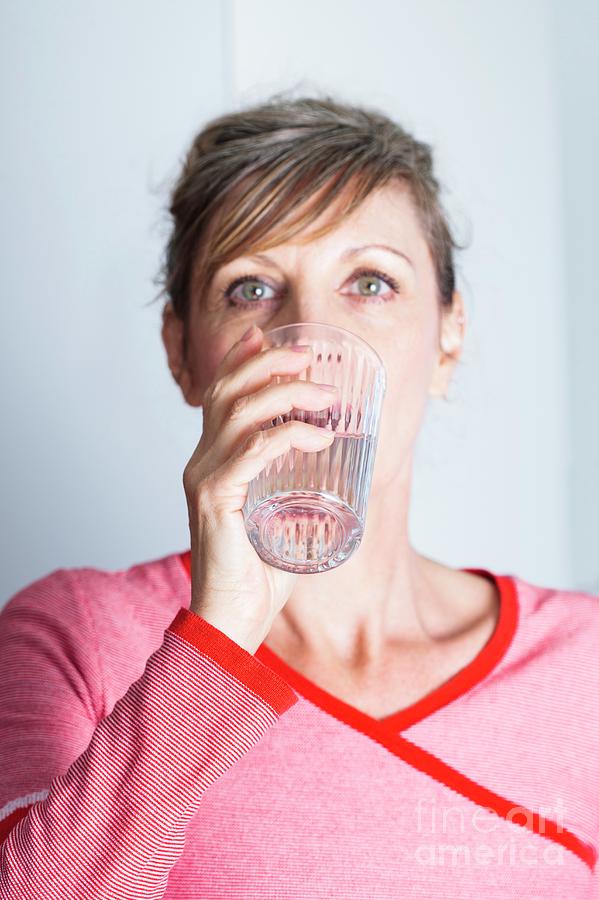 Woman Drinking Glass Of Water #1 Photograph by Cristina Pedrazzini/science Photo Library